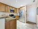 Cozy kitchen with stainless steel appliances, granite countertops, and lovely cabinetry at 230 Medallion Blvd # G, Madeira Beach, FL 33708