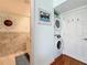 Hall laundry closet features a stacked washer and dryer with easy access at 230 Medallion Blvd # G, Madeira Beach, FL 33708