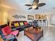 Cozy living room open to kitchen, featuring tile floors, leather seating, and stylish lighting at 230 Medallion Blvd # G, Madeira Beach, FL 33708