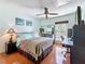 Bright bedroom with desk and chair, ceiling fan, hardwood floors, and natural light at 230 Medallion Blvd # G, Madeira Beach, FL 33708