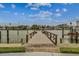 Waterfront pier for fishing or a leisurely stroll offers serene water views and a bench to relax at 230 Medallion Blvd # G, Madeira Beach, FL 33708