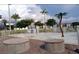 Community splash pad featuring lush landscaping, mature palm trees and nearby condominium homes at 230 Medallion Blvd # G, Madeira Beach, FL 33708