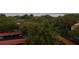 Lush aerial view with trees and buildings near water, and amenities for comfortable community living at 2699 Seville Blvd # 802, Clearwater, FL 33764