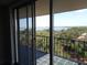 Balcony view with metal railings overlooking lush trees and a waterway at 2699 Seville Blvd # 802, Clearwater, FL 33764