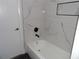 Modern bathroom with stylish tiled shower/tub and dark fixtures and new flooring at 2699 Seville Blvd # 802, Clearwater, FL 33764