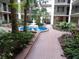 Beautiful courtyard view, showcasing a well-manicured garden and fountain, offering a serene community space at 2699 Seville Blvd # 802, Clearwater, FL 33764
