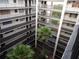 Beautiful courtyard with lush tropical plants and open-air walkways on all floors of the building at 2699 Seville Blvd # 802, Clearwater, FL 33764