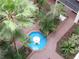 Bird's eye view of courtyard showcasing the blue fountain, lush greenery, and brick-paved pathways at 2699 Seville Blvd # 802, Clearwater, FL 33764
