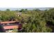 Scenic view showcasing the property with lush trees, covered parking, and distant water at 2699 Seville Blvd # 802, Clearwater, FL 33764