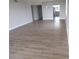 Bright, open living space with new wood-style flooring and neutral paint at 2699 Seville Blvd # 802, Clearwater, FL 33764