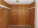 Walk-in closet with wood paneled walls and metal shelving offering ample space for wardrobe at 2699 Seville Blvd # 802, Clearwater, FL 33764