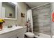 Charming bathroom showcases a shower with modern tile, floral curtain, and a bright white vanity at 2913 Fig Ct, Palm Harbor, FL 34684