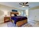 Bedroom features ceiling fan, wood-look floors, and ensuite bathroom for added convenience at 2913 Fig Ct, Palm Harbor, FL 34684