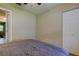 This bedroom features a ceiling fan, closet and a doorway leading to other parts of the home at 2913 Fig Ct, Palm Harbor, FL 34684