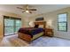 Well-lit bedroom features light wood floors, large windows, and a private balcony at 2913 Fig Ct, Palm Harbor, FL 34684