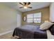 Comfortable bedroom featuring natural light, a ceiling fan, and a closet for storage at 2913 Fig Ct, Palm Harbor, FL 34684