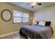 Cozy bedroom with ceiling fan, wood-look floors, and natural light from window at 2913 Fig Ct, Palm Harbor, FL 34684
