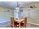 Cozy dining area features a modern light fixture, display shelving, and an open flow to adjacent rooms at 2913 Fig Ct, Palm Harbor, FL 34684