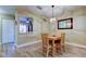 Elegant dining area with modern lighting, wood-style flooring, and an open design concept at 2913 Fig Ct, Palm Harbor, FL 34684