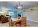 A stylish dining area boasting a contemporary chandelier, wood-look floors, and seamless living space integration at 2913 Fig Ct, Palm Harbor, FL 34684