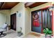 Welcoming entrance featuring a decorative wreath, potted plants, and a 'Hello' doormat at 2913 Fig Ct, Palm Harbor, FL 34684