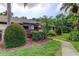 Exterior of home with mature landscaping, a garden bed, and a charming walkway at 2913 Fig Ct, Palm Harbor, FL 34684