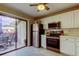 Stainless steel appliances and sliding glass doors leading to patio space fill this cozy kitchen at 2913 Fig Ct, Palm Harbor, FL 34684