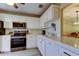 Well-lit kitchen featuring white cabinets, stainless steel appliances, and a functional layout at 2913 Fig Ct, Palm Harbor, FL 34684