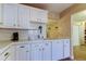 Fully equipped kitchen with ample counter space, white cabinets, and all essential appliances at 2913 Fig Ct, Palm Harbor, FL 34684
