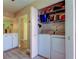 Convenient laundry closet featuring a full-size washer and dryer with shelving for organized storage at 2913 Fig Ct, Palm Harbor, FL 34684