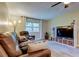 Comfortable living room offers modern media storage, neutral paint, and plush leather seating at 2913 Fig Ct, Palm Harbor, FL 34684