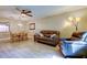 Relaxing living room with a modern ceiling fan, wood flooring, and comfortable seating at 2913 Fig Ct, Palm Harbor, FL 34684