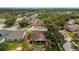 Aerial view of a residential neighborhood featuring mature trees and well-maintained lawns at 29713 Bright Ray Pl, Wesley Chapel, FL 33543
