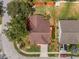 Aerial view of home with mature trees, landscaping, and long driveway at 29713 Bright Ray Pl, Wesley Chapel, FL 33543