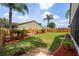 View of the backyard featuring a hammock, palm trees, landscaping, and a privacy fence at 29713 Bright Ray Pl, Wesley Chapel, FL 33543