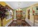 Bright dining area featuring a stylish chandelier, and an open view of the kitchen at 29713 Bright Ray Pl, Wesley Chapel, FL 33543