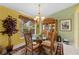 Dining area showcasing a glass table, decorative china cabinet, and elegant lighting at 29713 Bright Ray Pl, Wesley Chapel, FL 33543