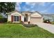 Charming single-Gathering home featuring a well-manicured lawn, lovely landscaping, and an attached two-car garage at 29713 Bright Ray Pl, Wesley Chapel, FL 33543