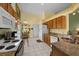 Well-lit kitchen featuring white appliances, tile flooring, and plentiful counter space at 29713 Bright Ray Pl, Wesley Chapel, FL 33543