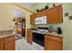 Well-lit kitchen features tile flooring, granite countertops and light wood cabinetry at 29713 Bright Ray Pl, Wesley Chapel, FL 33543