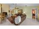 Cozy living room with neutral paint, tile floors, comfortable seating, and views of the dining area at 29713 Bright Ray Pl, Wesley Chapel, FL 33543