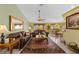 Open living space with neutral walls, tile flooring, comfortable seating, and an adjacent dining area at 29713 Bright Ray Pl, Wesley Chapel, FL 33543