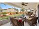 Enclosed patio with seating, ceiling fans, and a view of the backyard at 29713 Bright Ray Pl, Wesley Chapel, FL 33543