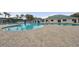 Beautiful community pool with an expansive pool deck, lounge chairs and umbrellas for shade at 29713 Bright Ray Pl, Wesley Chapel, FL 33543