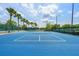 Community tennis court surrounded by a fence and mature landscaping at 29713 Bright Ray Pl, Wesley Chapel, FL 33543