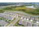 Aerial view of neighborhood, pond, and homes in a planned residential community at 32231 Conchshell Sail St, Wesley Chapel, FL 33545