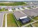 Aerial view showcases the property's screened-in patio and surroundings with nearby lake views at 32231 Conchshell Sail St, Wesley Chapel, FL 33545