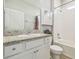 Bathroom features a granite countertop vanity, white cabinets and a shower-tub combo at 32231 Conchshell Sail St, Wesley Chapel, FL 33545