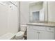 Bathroom with walk-in shower, white cabinets, granite countertop and tile floor at 32231 Conchshell Sail St, Wesley Chapel, FL 33545