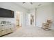 Bright bedroom with gray carpet and walk through access to the bathroom and entry hall at 32231 Conchshell Sail St, Wesley Chapel, FL 33545